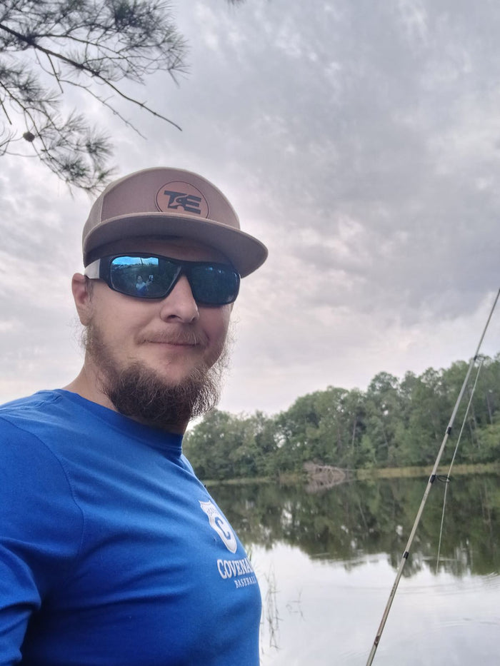 Lifestyle photo of Turn Em Outdoors Heritage Khaki Richardson leather patch trucker hat
