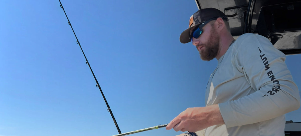 Lifestyle photo of Turn Em Outdoors performance fishing shirt on a center console boat