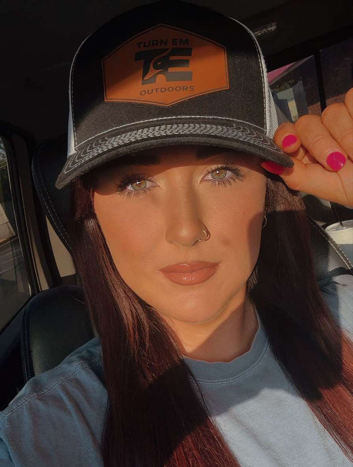 Lifestyle photo of Turn Em Outdoors Midnight Richardson 112FP leather patch trucker hat