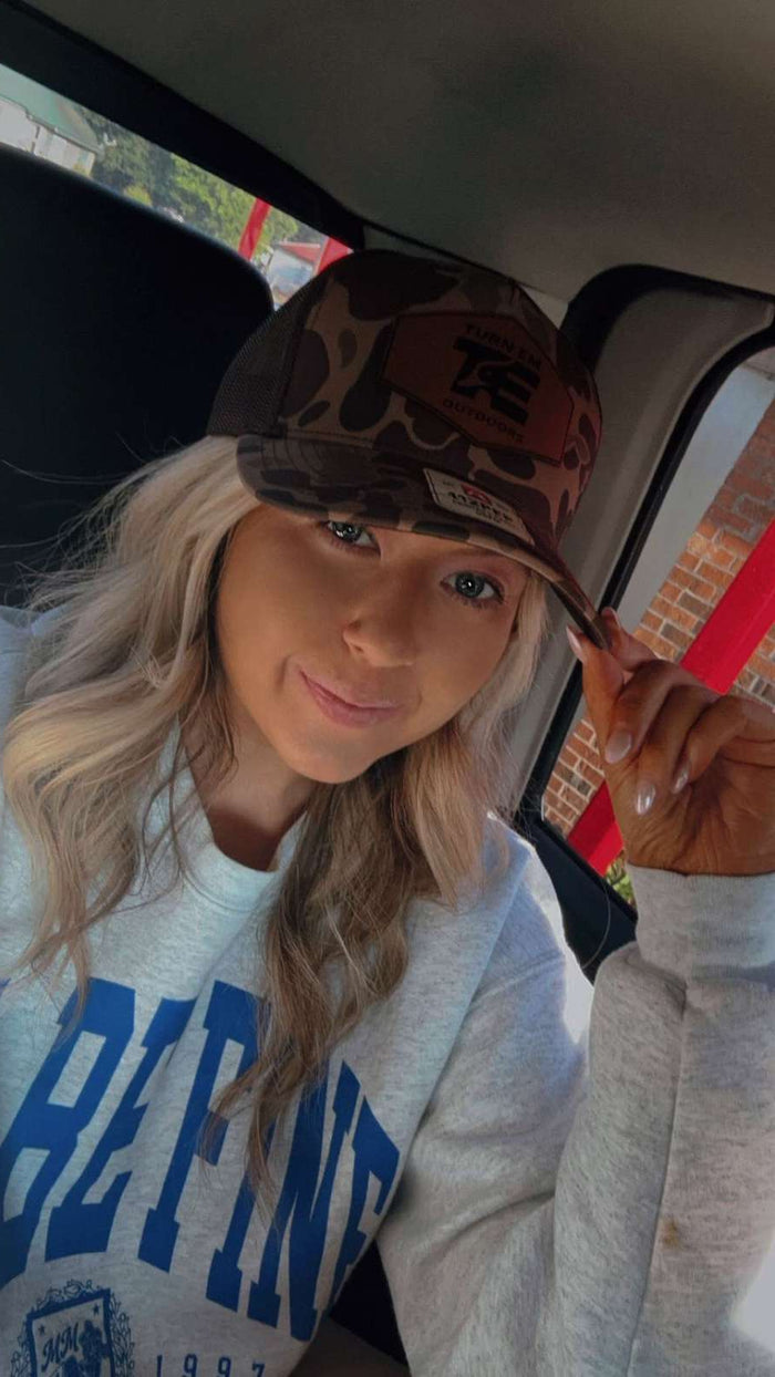 Turn Em Outdoors Timber Camo Richardson leather patch trucker hat worn outdoors
